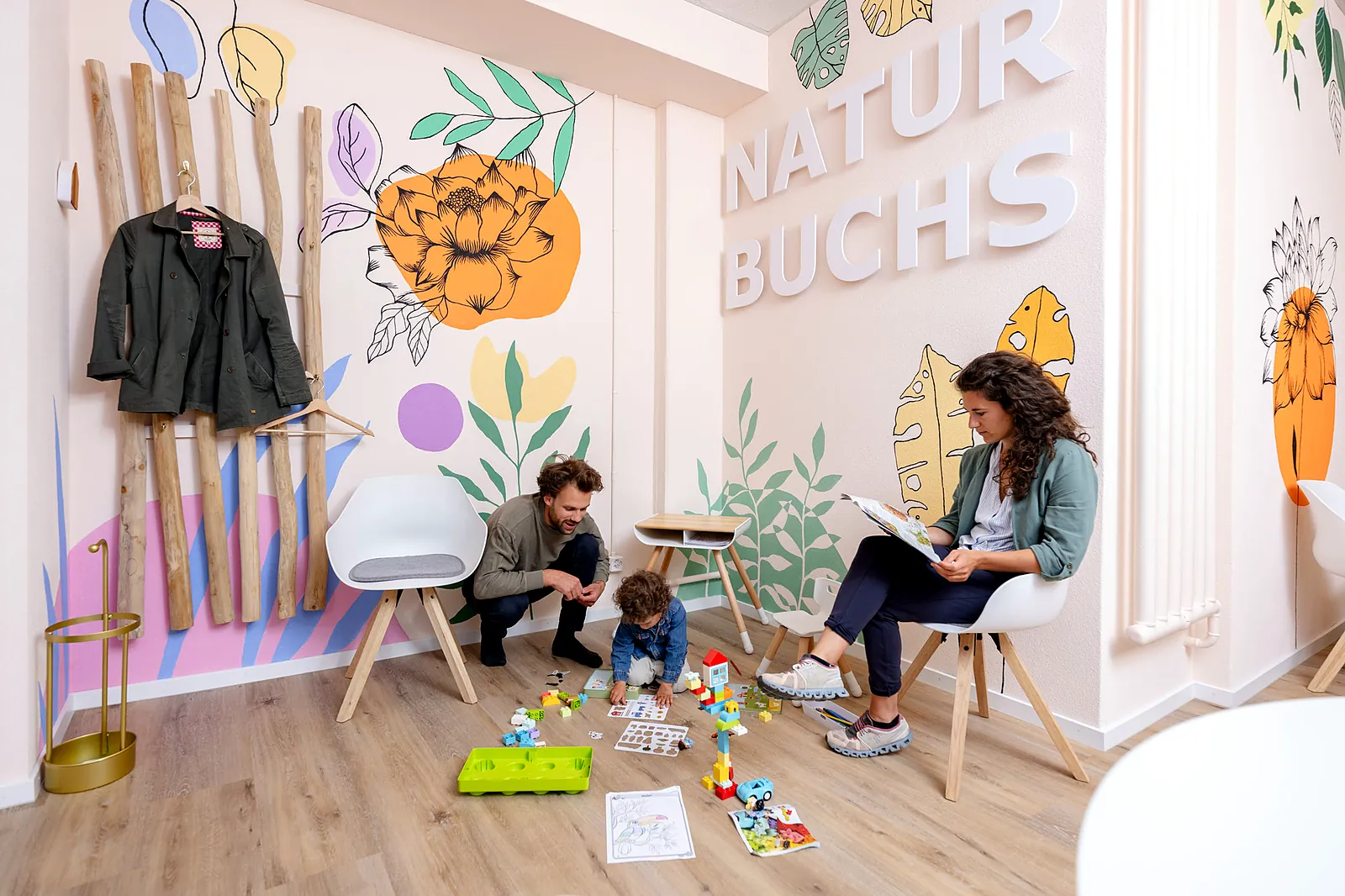 Empfangs- und Wartebereich im NaturBuchs mit Wandmalerei und Spielecke